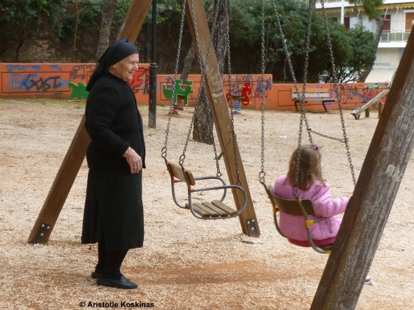 Grandmother and granddaughter at a playground, Athens, Greece